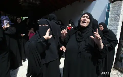 Relatives of two Palestinian children Mohammed and Omar al-Brim, who witnesses said were killed in an Israeli air strike before a ceasefire was declared, mourn during their funeral in Khan Younis in the southern Gaza Str...