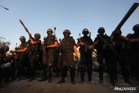 Palestinian militants of Izzedine al-Qassam Brigades, military wing of Hamas, and their supporters celebrate a victory rally at the debris of destroyed houses in Shijaiyah, neighborhood of Gaza City, in the northern Gaza...