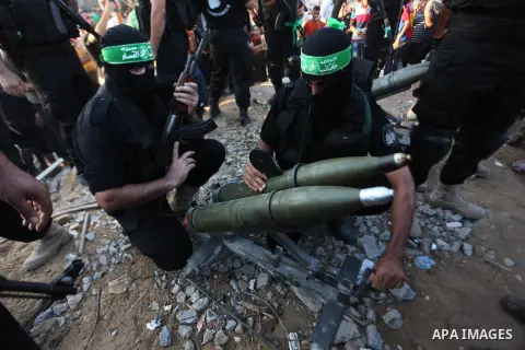 Palestinian militants of Izzedine al-Qassam Brigades, military wing of Hamas, and their supporters celebrate a victory rally at the debris of destroyed houses in Shijaiyah, neighborhood of Gaza City, in the northern Gaza...