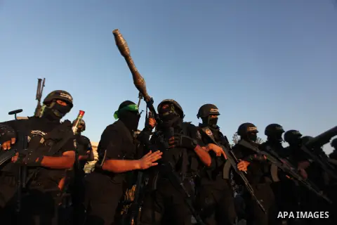 Palestinian militants of Izzedine al-Qassam Brigades, military wing of Hamas, and their supporters celebrate a victory rally at the debris of destroyed houses in Shijaiyah, neighborhood of Gaza City, in the northern Gaza...