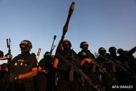 Palestinian militants of Izzedine al-Qassam Brigades, military wing of Hamas, and their supporters celebrate a victory rally at the debris of destroyed houses in Shijaiyah, neighborhood of Gaza City, in the northern Gaza...