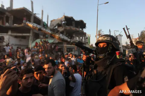Palestinian militants of Izzedine al-Qassam Brigades, military wing of Hamas, and their supporters celebrate a victory rally at the debris of destroyed houses in Shijaiyah, neighborhood of Gaza City, in the northern Gaza...