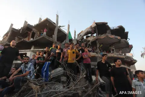 Palestinian militants of Izzedine al-Qassam Brigades, military wing of Hamas, and their supporters celebrate a victory rally at the debris of destroyed houses in Shijaiyah, neighborhood of Gaza City, in the northern Gaza...