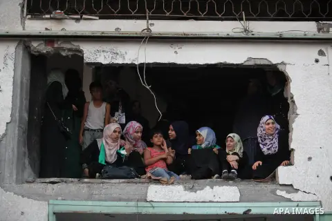 Palestinian militants of Izzedine al-Qassam Brigades, military wing of Hamas, and their supporters celebrate a victory rally at the debris of destroyed houses in Shijaiyah, neighborhood of Gaza City, in the northern Gaza...