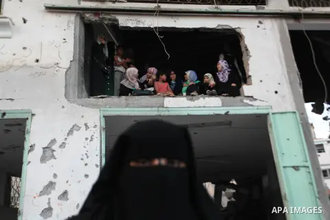 Palestinian militants of Izzedine al-Qassam Brigades, military wing of Hamas, and their supporters celebrate a victory rally at the debris of destroyed houses in Shijaiyah, neighborhood of Gaza City, in the northern Gaza...