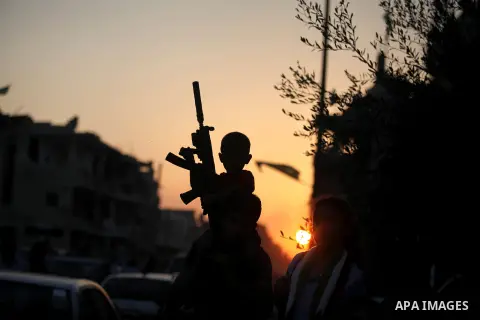 Palestinian militants of Izzedine al-Qassam Brigades, military wing of Hamas, and their supporters celebrate a victory rally at the debris of destroyed houses in Shijaiyah, neighborhood of Gaza City, in the northern Gaza...
