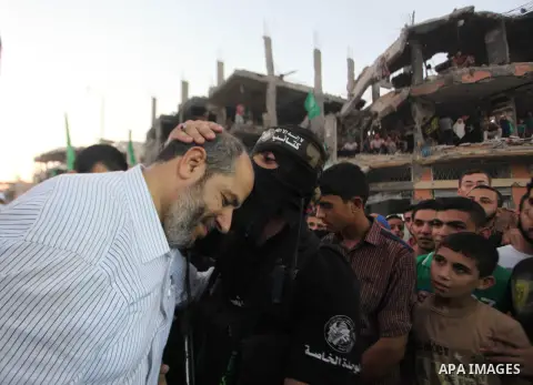 Palestinian militants of Izzedine al-Qassam Brigades, military wing of Hamas, and their supporters celebrate a victory rally at the debris of destroyed houses in Shijaiyah, neighborhood of Gaza City, in the northern Gaza...