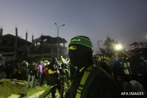 Palestinian militants of Izzedine al-Qassam Brigades, military wing of Hamas, and their supporters celebrate a victory rally at the debris of destroyed houses in Shijaiyah, neighborhood of Gaza City, in the northern Gaza...