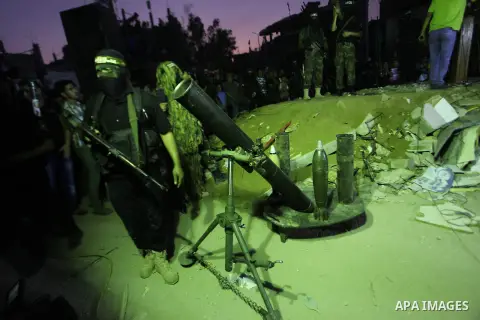 Palestinian militants of Izzedine al-Qassam Brigades, military wing of Hamas, and their supporters celebrate a victory rally at the debris of destroyed houses in Shijaiyah, neighborhood of Gaza City, in the northern Gaza...