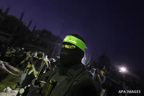 Palestinian militants of Izzedine al-Qassam Brigades, military wing of Hamas, and their supporters celebrate a victory rally at the debris of destroyed houses in Shijaiyah, neighborhood of Gaza City, in the northern Gaza...