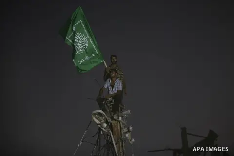 Palestinian militants of Izzedine al-Qassam Brigades, military wing of Hamas, and their supporters celebrate a victory rally at the debris of destroyed houses in Shijaiyah, neighborhood of Gaza City, in the northern Gaza...