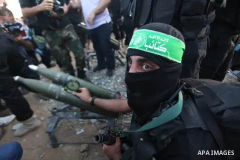 Palestinian militants of Izzedine al-Qassam Brigades, military wing of Hamas, and their supporters celebrate a victory rally at the debris of destroyed houses in Shijaiyah, neighborhood of Gaza City, in the northern Gaza...