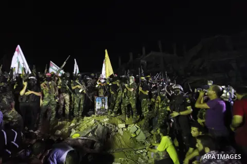Palestinian militants of Izzedine al-Qassam Brigades, military wing of Hamas, and their supporters celebrate a victory rally at the debris of destroyed houses in Shijaiyah, neighborhood of Gaza City, in the northern Gaza...