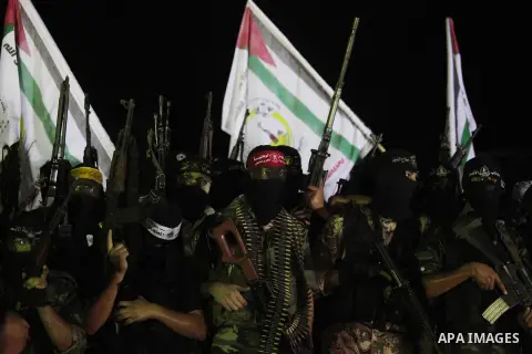 Palestinian militants of Izzedine al-Qassam Brigades, military wing of Hamas, and their supporters celebrate a victory rally at the debris of destroyed houses in Shijaiyah, neighborhood of Gaza City, in the northern Gaza...
