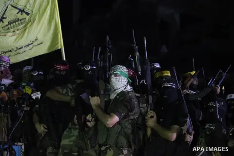 Palestinian militants of Izzedine al-Qassam Brigades, military wing of Hamas, and their supporters celebrate a victory rally at the debris of destroyed houses in Shijaiyah, neighborhood of Gaza City, in the northern Gaza...