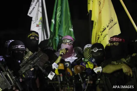 Palestinian militants of Izzedine al-Qassam Brigades, military wing of Hamas, and their supporters celebrate a victory rally at the debris of destroyed houses in Shijaiyah, neighborhood of Gaza City, in the northern Gaza...