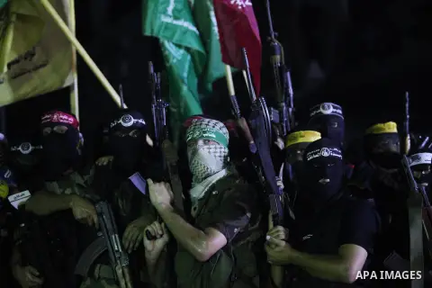 Palestinian militants of Izzedine al-Qassam Brigades, military wing of Hamas, and their supporters celebrate a victory rally at the debris of destroyed houses in Shijaiyah, neighborhood of Gaza City, in the northern Gaza...