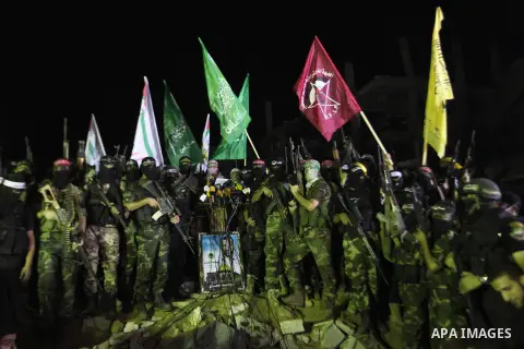 Palestinian militants of Izzedine al-Qassam Brigades, military wing of Hamas, and their supporters celebrate a victory rally at the debris of destroyed houses in Shijaiyah, neighborhood of Gaza City, in the northern Gaza...