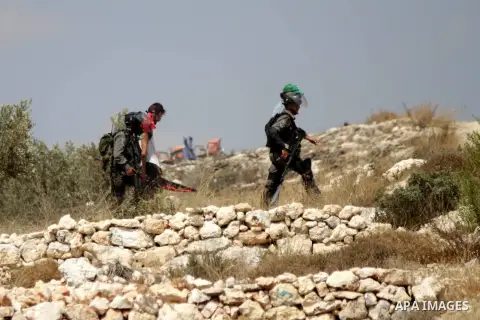 Members of the Israeli security forces arrest an Israeli demonstrating in solidarity with Palestinian protestors in the village of Bilin, near the West Bank city of Ramallah following a march in support of the resistance...