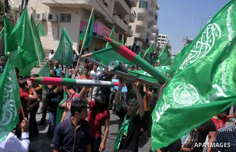 Palestinian boys hold a mock rocket during a rally following the Friday prayers, three days after a deal hailed by Israel and Hamas as 'victory' in the 50-day war on August 29, 2014 in the West Bank town of Hebron. Thous...