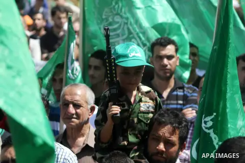 Palestinian boys hold a mock rocket during a rally following the Friday prayers, three days after a deal hailed by Israel and Hamas as 'victory' in the 50-day war on August 29, 2014 in the West Bank town of Hebron. Thous...