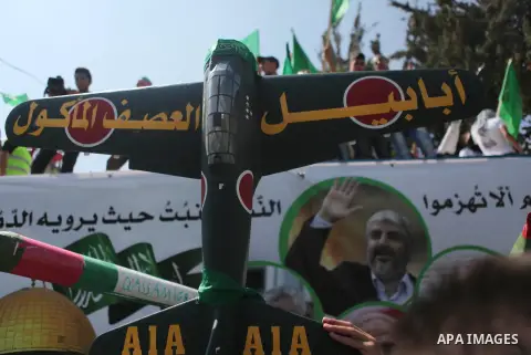 A Palestinian supporter of the Hamas Islamist movement holds a mock rocket during a rally following the Friday prayers, three days after a deal hailed by Israel and Hamas as 'victory' in the 50-day war on August 29, 2014...
