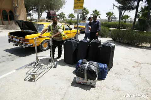 Palestinians wait to be given the permission to cross into Egypt at the Rafah border crossing in the southern Gaza Strip, on August 28, 2014. The Rafah crossing with Egypt is Gaza's only gateway to the world that is not...