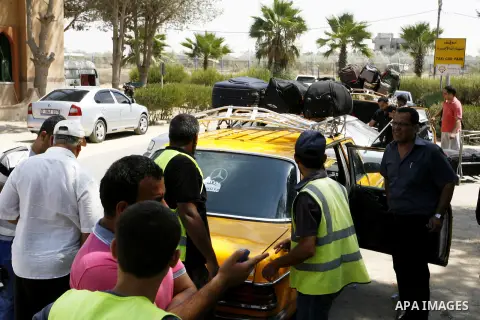 Palestinians wait to be given the permission to cross into Egypt at the Rafah border crossing in the southern Gaza Strip, on August 28, 2014. The Rafah crossing with Egypt is Gaza's only gateway to the world that is not...