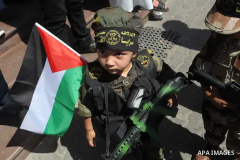 A Palestinian boy holds a replica gun as Palestinians in a rally celebrating what they say was a victory over Israel following a ceasefire in Gaza City August 29, 2014. An open-ended ceasefire, mediated by Egypt, took ef...