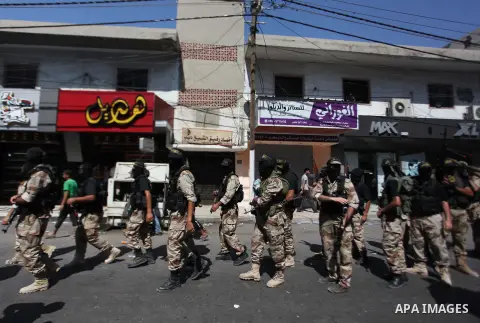 Palestinian Islamic Jihad militants take part in a rally celebrating what they say was a victory over Israel following a ceasefire in Gaza City August 29, 2014. An open-ended ceasefire, mediated by Egypt, took effect on...