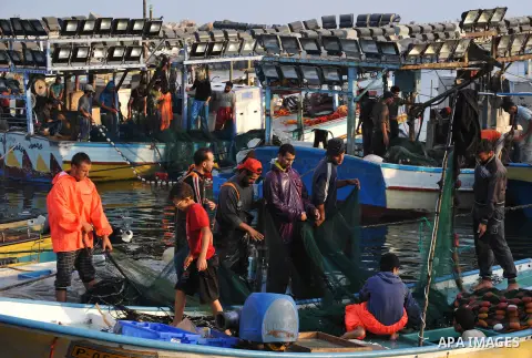 Palestinian fishermen clean their boats at Gaza's seaport in Gaza City early on August 29, 2014. Israel and Hamas accepted an Egyptian proposal for a long-term ceasefire in war-torn Gaza on August 26 in a move to end 50...