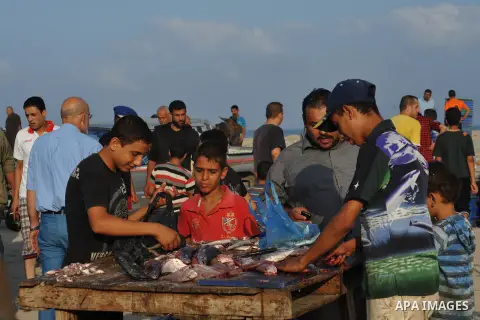 A Palestinian fisherman sells fish at Gaza's seaport in Gaza City early on August 29, 2014. Israel and Hamas accepted an Egyptian proposal for a long-term ceasefire in war-torn Gaza on August 26 in a move to end 50 days...