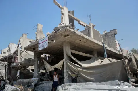 A Palestinian man sits on the rubble of his house which witnesses said was destroyed during the Israeli offensive in Shejaiya neighborhood after a ceasefire was declared, in Gaza city on August 30, 2014. An open-ended ce...