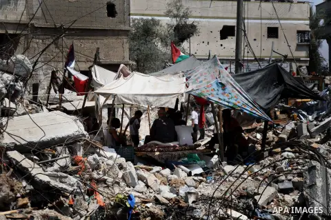 Palestinians sit at a tent on a the rubble of their house which witnesses said was destroyed during the Israeli offensive in Shejaiya neighborhood after a ceasefire was declared, in Gaza city on August 30, 2014. An open-...