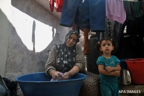 A Palestinian woman washes clothes on the rubble of their house which witnesses said was destroyed during the Israeli offensive in Shejaiya neighborhood after a ceasefire was declared, in Gaza city on August 30, 2014. An...