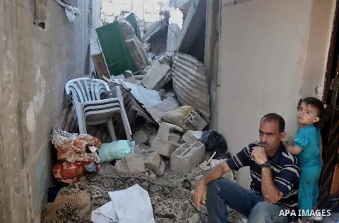 A Palestinian man sits on the rubble of his house which witnesses said was destroyed during the Israeli offensive in Shejaiya neighborhood after a ceasefire was declared, in Gaza city on August 30, 2014. An open-ended ce...