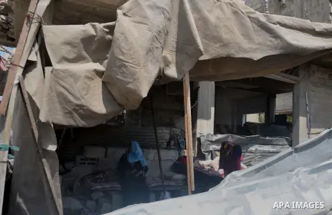 A Palestinian woman sits at a tent on a the rubble of his house which witnesses said was destroyed during the Israeli offensive in Shejaiya neighborhood after a ceasefire was declared, in Gaza city on August 30, 2014. An...