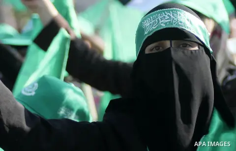 A masked Palestinian woman takes part during a celebrate in a victory by Palestinians in Gaza over Israel following a ceasefire, in the West Bank city of Ramallah August 30, 2014. An open-ended ceasefire, mediated by Egy...