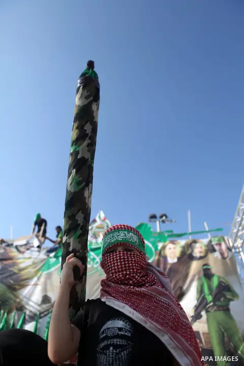 A masked Palestinian boy holds a mock rocket during a celebrate in a victory by Palestinians in Gaza over Israel following a ceasefire, in the West Bank city of Ramallah August 30, 2014. An open-ended ceasefire, mediated...