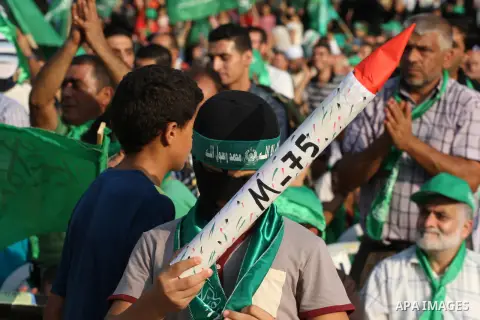 A masked Palestinian boy holds a mock rocket during a rally showing their support and solidarity with Hamas in the West Bank city of Tulkarem, 30 August 2014. An indefinite ceasefire to end seven weeks of fighting betwee...