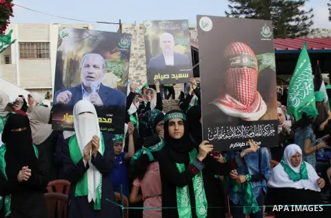 Palestinians who support the Islamic Hamas movement hold a rally showing their support and solidarity with Hamas in the West Bank city of Tulkarem, 30 August 2014. An indefinite ceasefire to end seven weeks of fighting b...