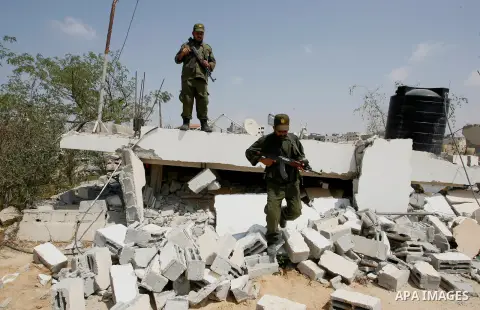 Palestinian security forces inspect security headquarters destroyed during fighting between Hamas militants and Israel on the border between Egypt and Gaza in Rafah, southern Gaza Strip in August 31, 2014. An indefinite...