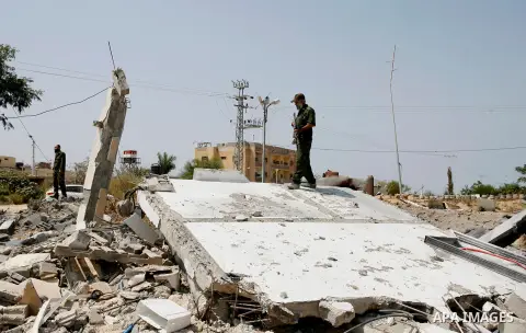 Palestinian security forces inspect security headquarters destroyed during fighting between Hamas militants and Israel on the border between Egypt and Gaza in Rafah, southern Gaza Strip in August 31, 2014. An indefinite...