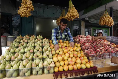 A Palestinian vendor sells fruits at his shop in Rafah in the southern Gaza Strip, o n Sep. 01, 2014. Calm returned to the coastal enclave in a August 26 ceasefire, and Gazans were gradually starting to rebuild their liv...