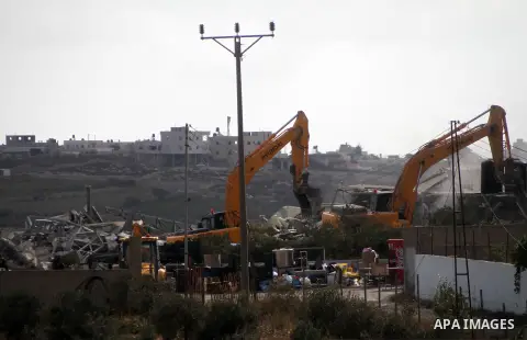 Israeli bulldozers demolish a dairy factory, at the al-Rama neighborhood near the West Bank city of Hebron on September 2, 2014. Israeli bulldozers demolished a dairy factory in Hebron and Bedouin homes east of Jerusalem...