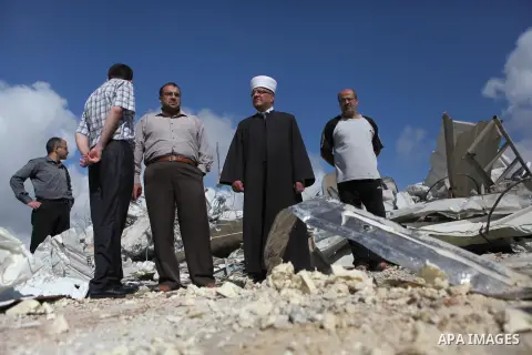 Palestinians inspect the rubble of a dairy factory demolished by Israeli bulldozers, at the al-Rama neighborhood near the West Bank city of Hebron on September 2, 2014. Israeli bulldozers demolished a dairy factory in He...