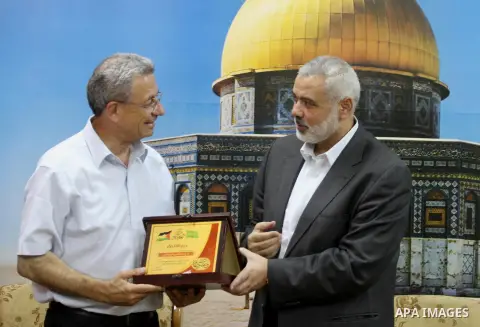 Palestinian top Hamas leader in Gaza, Ismail Haniyeh meets with Palestinian legislator Mustafa Barghouti, in Gaza City September 2, 2014. Photo by Mohammed Asad