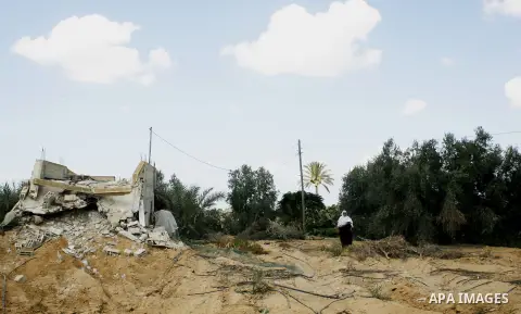 A Palestinian woman inspects her farmland which destroyed during fighting between Hamas militants and Israel near the Israeli Gaza border fence in east of Khan Younis, southern Gaza Strip September 2, 2014. An open-ended...