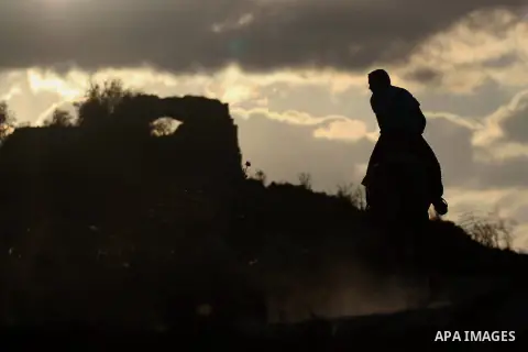 A Palestinian youth rides a horse during sunset in the West Bank city of Rammallah on September 2, 2014. Photo by Shadi Hatem