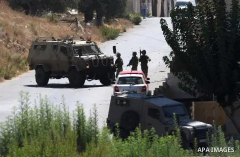 Palestinian youths throw at Israeli military patrols during a military operation at Ein Beit Alma' refugee camp near the West Bank city of Nablus, on Sep. 03, 2014. Photo by Nedal Eshtayah